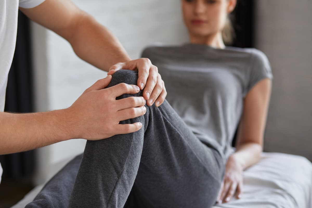 Physical therapist working with patient